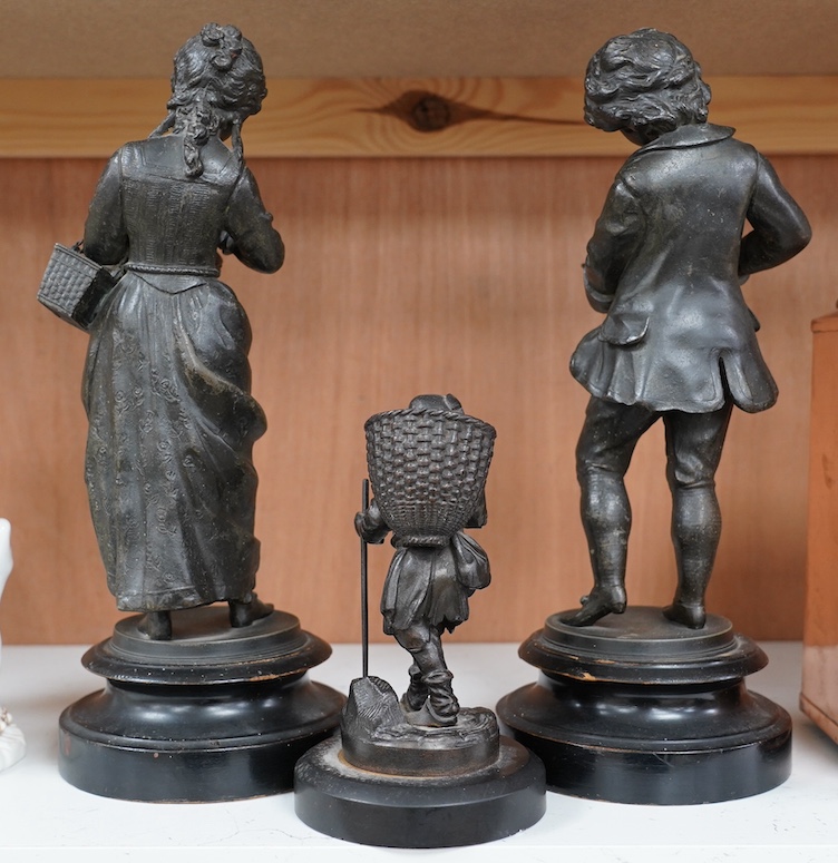 A Victorian bronze figure of a man carrying basket and a pair spelter figures, 32cm. Condition - fair to good, a little worn, particularly bases